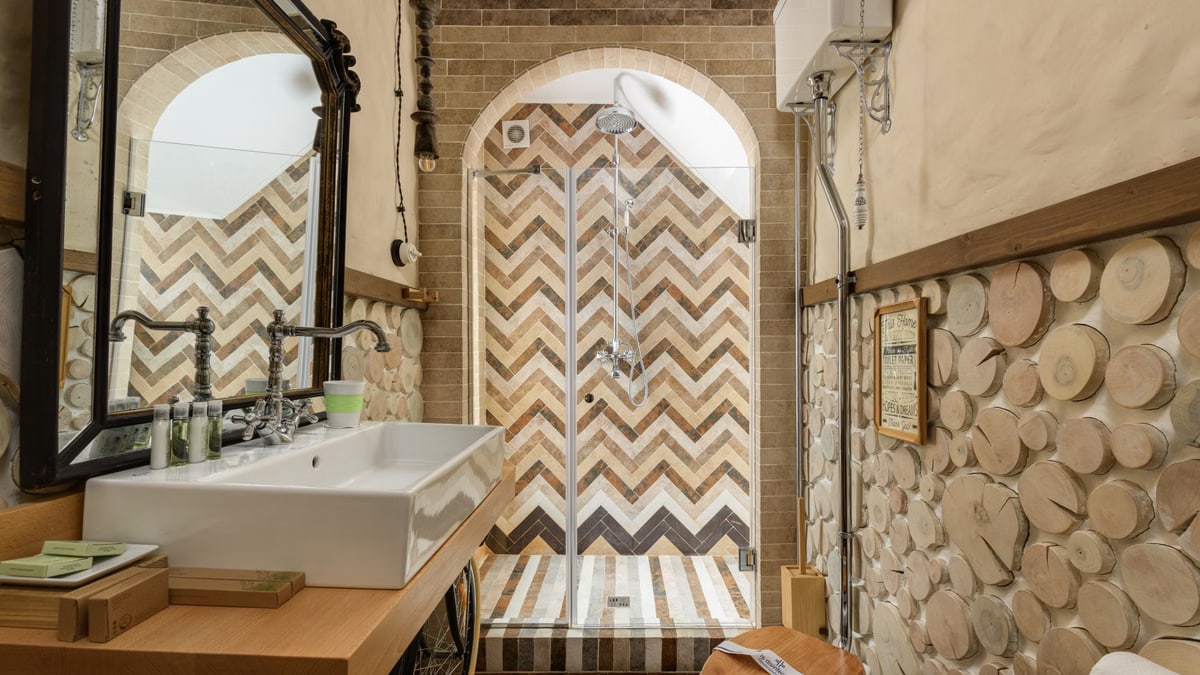 Stylish rustic bathroom featuring a herringbone shower design and natural elements.